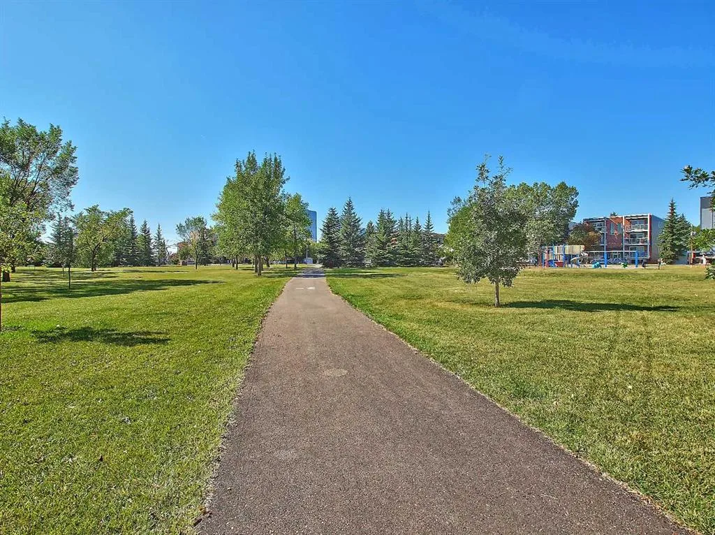 Paved walking path through a Renfrew green space